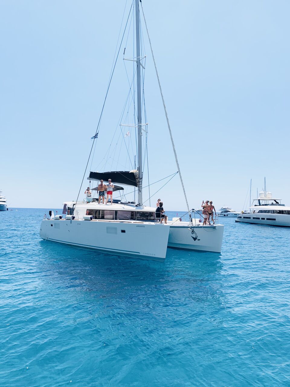 Catamaran at anchor in clear water