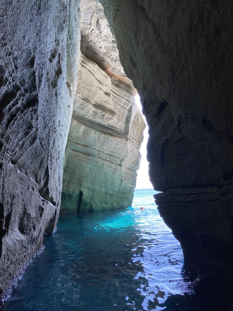 Swimming by a rock cave