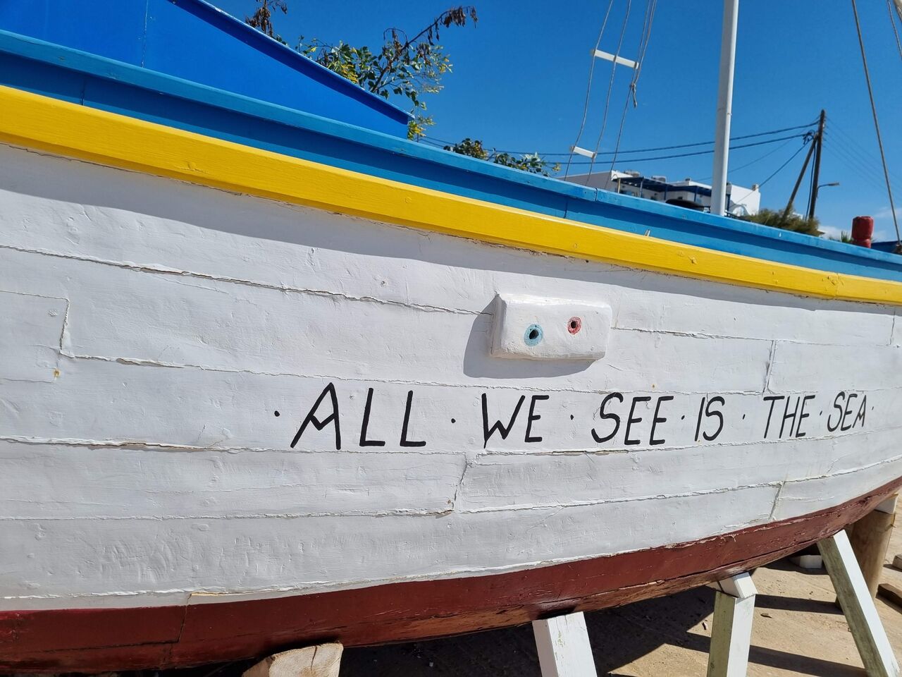 Wooden boat with the words All we see is the sea